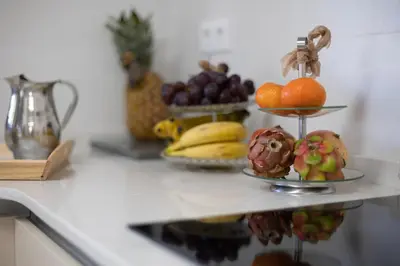 a counter with fruits and vegetables on a shelf at Villa Huerta 1 Manises, jacuzzi, sauna, piscina in Manises