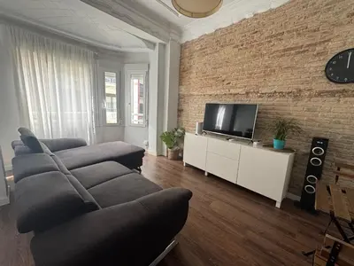 a living room with a couch and a flat screen tv at amazing cozy apartment super central in Valencia