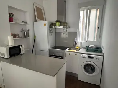 a kitchen with a refrigerator and a washing machine at amazing cozy apartment super central in Valencia