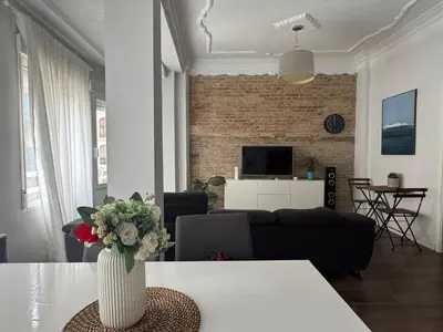 a living room with a vase of flowers on a table at amazing cozy apartment super central in Valencia