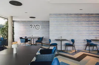a room with chairs and tables and a wall with the number at Barceló Valencia in Valencia