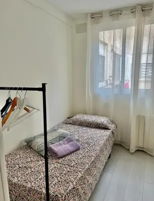 two beds in a room with a window at Apartamento Cuidad Ciencias in Valencia