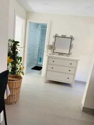 a white dresser with a mirror on top of it at Apartamento Cuidad Ciencias in Valencia