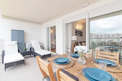 a dining room with a table with blue plates on it at Global Vacacional, Moderno apartamento en Canet al Mar in Canet de Berenguer