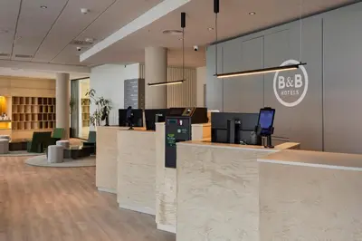 a lobby of a bedia office with reception desks at B&B HOTEL Valencia Arena in Valencia