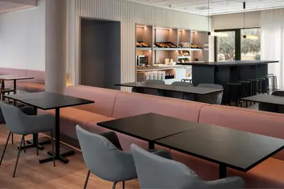 a restaurant with tables and chairs and a bar at B&B HOTEL Valencia Arena in Valencia
