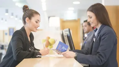 two women sitting at a table looking at a book at Holiday Inn Express Valencia Bonaire by IHG in Aldaya