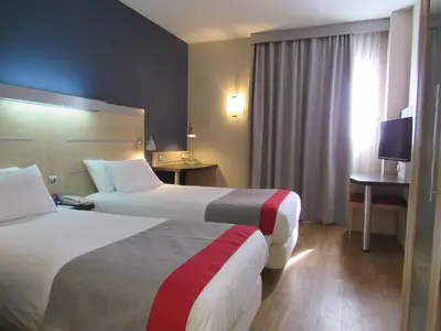 a hotel room with two beds and a window at Holiday Inn Express Valencia Bonaire by IHG in Aldaya