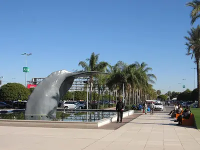 a metal sculpture in a park with palm trees at Holiday Inn Express Valencia Bonaire by IHG in Aldaya