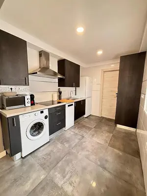 a kitchen with a washer and dryer in it at Apartamento Sofía II a 500m de la playa in Puerto de Sagunto