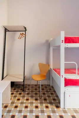 a room with two bunk beds and a chair at Red Nest Hostel in Valencia