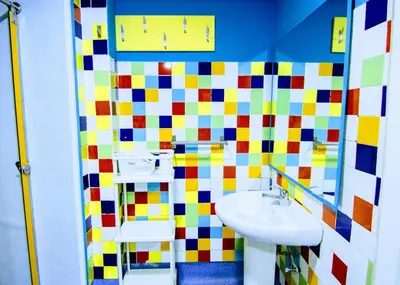 a bathroom with a sink and a colorful tile wall at Red Nest Hostel in Valencia
