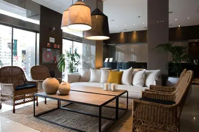 a living room with a white couch and a table at Zenit Valencia in Valencia