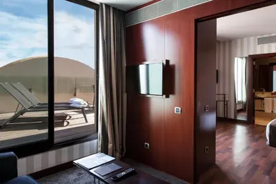 a room with a large glass door with a balcony at Zenit Valencia in Valencia