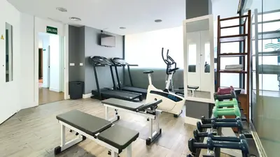 a gym with treadmills and exercise equipment in a room at Sea You Hotel Port Valencia in Valencia