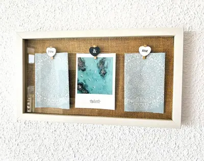 a picture frame hanging on a wall with pictures at The Beach Apartment in El Puig