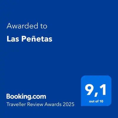 a blue text box with the words awarded to las peritesias at Las Peñetas in Bolbaite