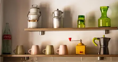 a shelf filled with different colored glass bottles at Ca La Abuela in Requena