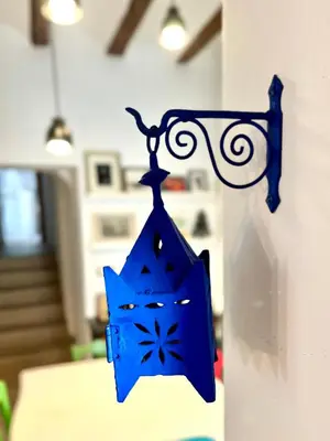 a blue object is hanging on a wall at Ca La Abuela in Requena