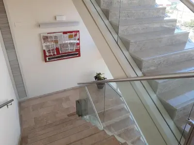 a staircase in a house with a glass railing at Hotel Xon's Valencia in Aldaya
