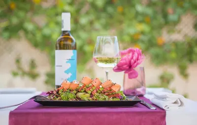 a plate of food and a glass of wine on a table at Hotel Xon's Valencia in Aldaya