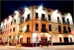a large white building with lights on top of it at Hotel Rioja in Benisanó