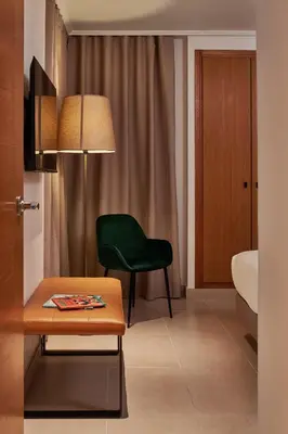 a living room with a green chair and a table at Sea view modern flat in Alboraya