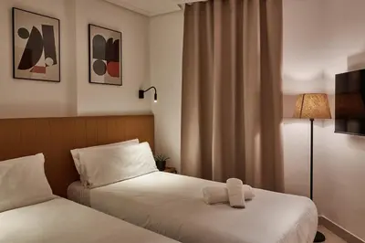 a hotel room with two beds and a window at Sea view modern flat in Alboraya