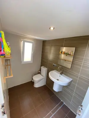 a bathroom with a toilet and a sink at Casa junto al mar con jardín in Sagunto