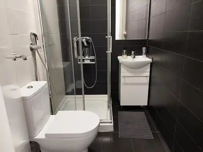 a bathroom with a toilet and a shower and a sink at Apartamentos Rous - Solo adultos in Valencia