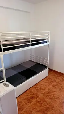 a white bunk bed in a room at appartement pied dans l eau in El Brosquil
