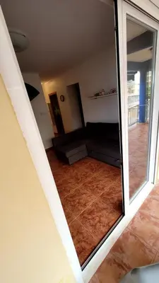 a view of a living room with a sliding glass door at appartement pied dans l eau in El Brosquil