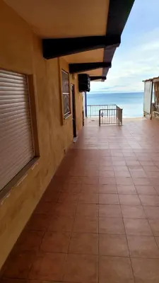 a tiled hallway with a view of the ocean at appartement pied dans l eau in El Brosquil
