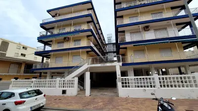 a building with a car parked in front of it at appartement pied dans l eau in El Brosquil