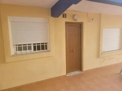 a room with a door and two windows at appartement pied dans l eau in El Brosquil