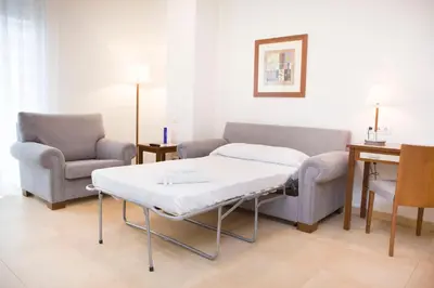 a hospital room with a table and two chairs at Aparthotel Albufera in Alfafar