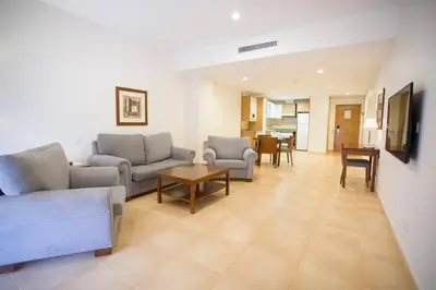 a living room with two couches and a table at Aparthotel Albufera in Alfafar