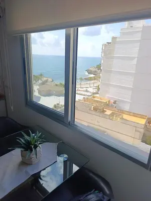 a window in a room with a view of the ocean at Precioso apartamento en el Faro de Cullera in Cullera