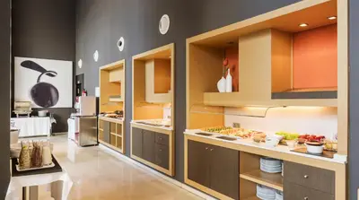 a large kitchen with many open cabinets and food at Ilunion Aqua 3 in Valencia