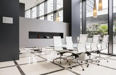 a conference room with white chairs and a fireplace at Ilunion Aqua 4 in Valencia