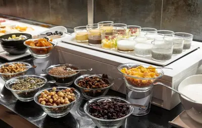 a buffet with many bowls of different types of food at Ilunion Aqua 4 in Valencia