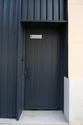 a black garage door with a sign on it at Patacona by Concept Flats in Valencia