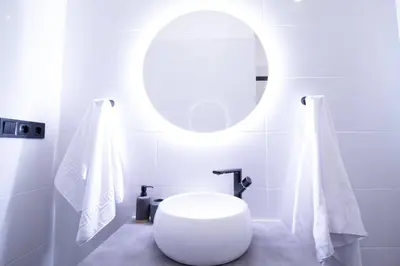 a bathroom with a white toilet and a mirror at Patacona by Concept Flats in Valencia