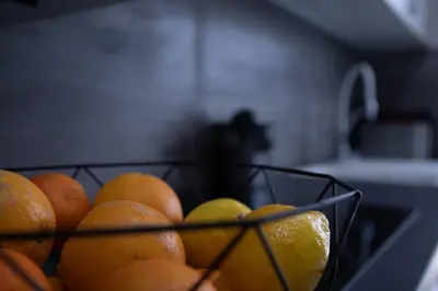 a bowl of oranges and lemons sitting on a counter at Patacona by Concept Flats in Valencia
