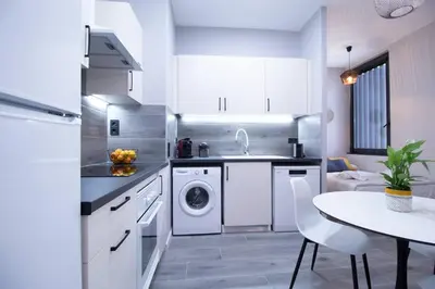 a kitchen with a washing machine and a table at Patacona by Concept Flats in Valencia