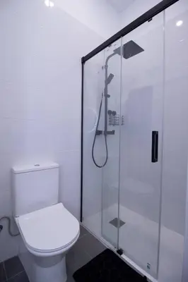 a bathroom with a toilet and a glass shower at Patacona by Concept Flats in Valencia