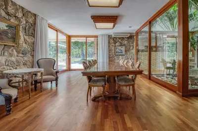 a dining room with a wooden table and chairs at Villa Montgrau in Llano de Gorra