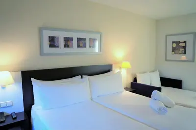 a hotel room with two beds with white pillows at Port Feria Valencia in Valencia