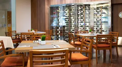 a restaurant with wooden tables and chairs and a wine cellar at Port Feria Valencia in Valencia
