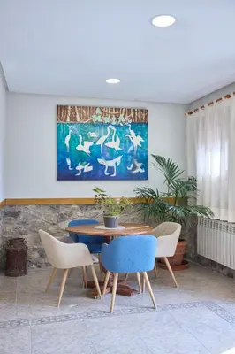 a dining room with a table and chairs and a painting at Hotel De Jerica in Jérica